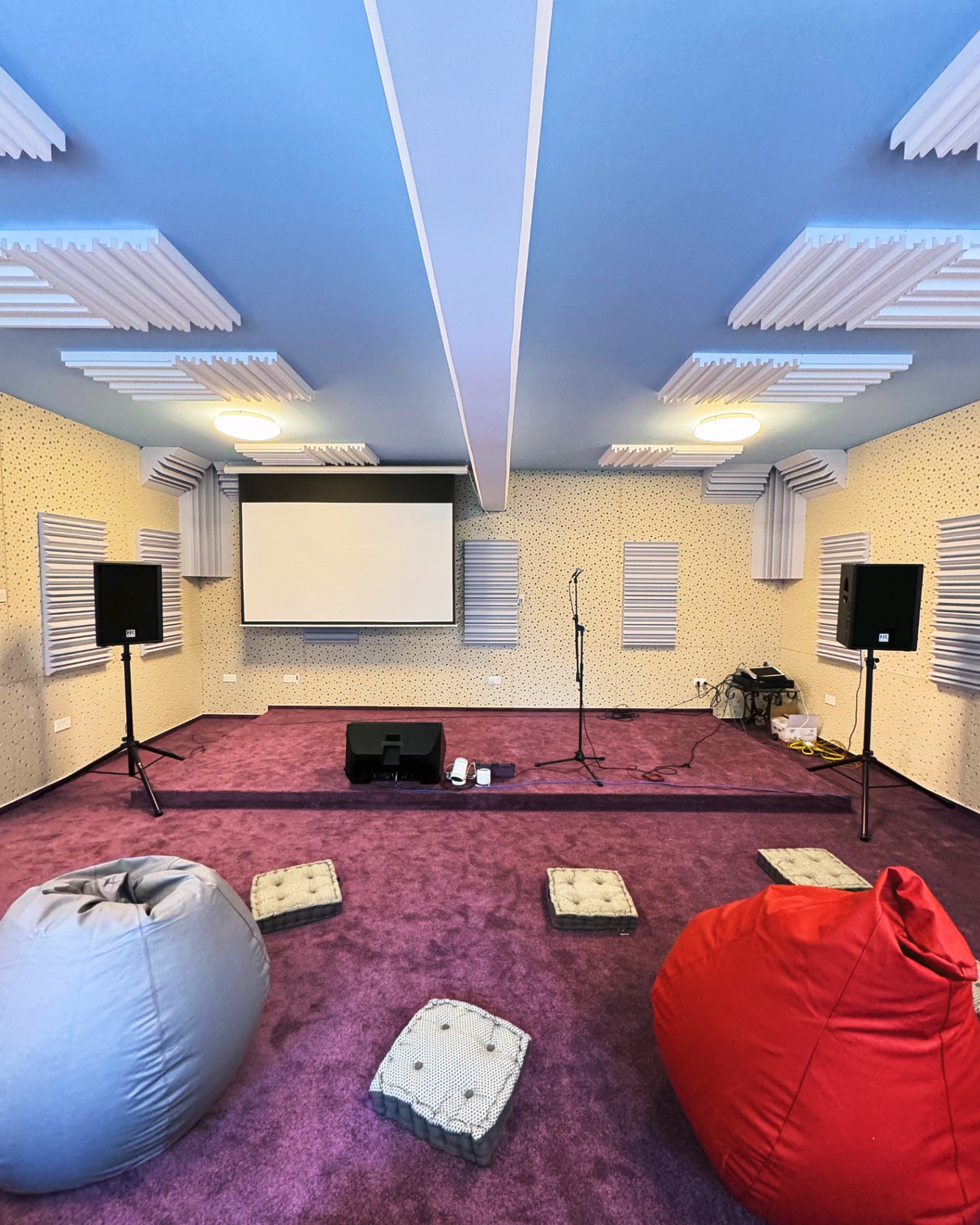 Cinema setup with projector screen and beanbags